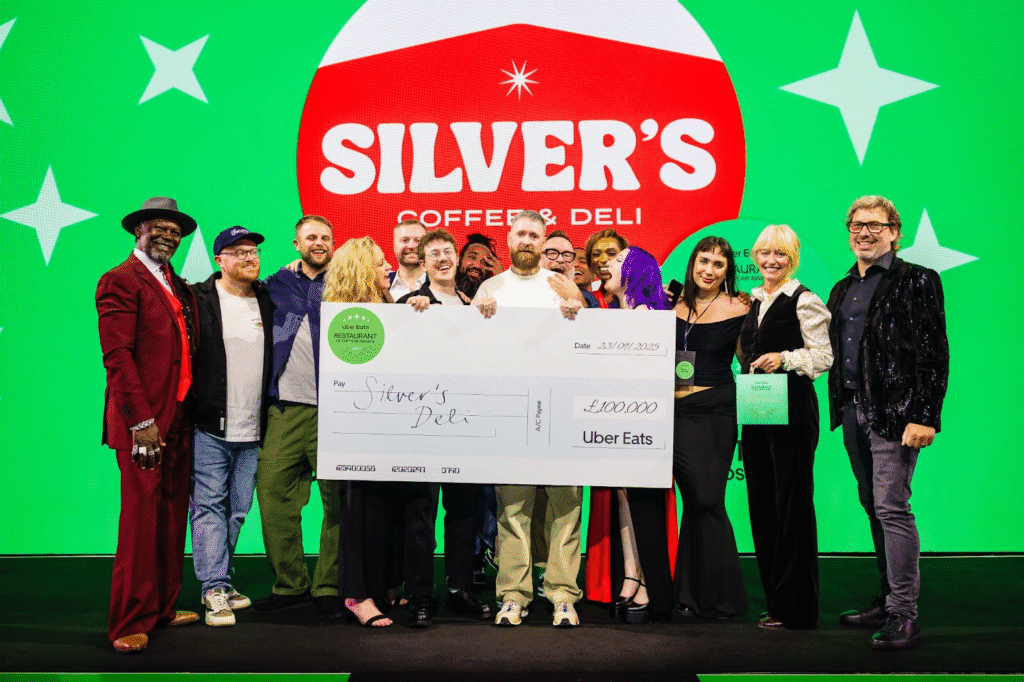 Uber Eats has today revealed that Silver’s Deli from Leeds has been crowned the 2025 Restaurant of the Year, taking home the £100,000 grand prize to invest in their business.Selected from more than 130 nominated restaurants across the UK and Ireland, Silver’s Deli stood out for its big flavours and compelling story of entrepreneurship, impressing both the judges and the public in a competition designed to spotlight the very best of small, independent restaurants.In its fourth year, the Uber Eats Restaurant of the Year Awards continue to celebrate the small and independent restaurants that fuel local communities and shape the UK and Ireland’s food culture. Each of the 12 regional finalists will receive £5,000 and tailored support from Uber Eats, after facing off in London for the ultimate £100,000 prize.Matthew Price, General Manager of Uber Eats UK, Ireland and Northern Europe, said: “Independent restaurants are the beating heart of our food scene. Silver’s Deli embodies everything these awards are about: creativity, resilience, and a commitment to serving their community. We’re proud to support their journey and can’t wait to see how they use this prize to grow their business.”Judges included food entrepreneur Levi Roots, Irish celebrity chef Clodagh McKenna, 2024 winner Natty Crutchfield, foodie creator Eating with Todd, and Lorraine Copes, CEO and founder of Be Inclusive Hospitality.Alongside the main award, five Trailblazer Awards were announced, celebrating innovation and positive change in the industry. The judging panel featured big names from across food, media, and sustainability — including Chef’s Table star Asma Khan, TikTok creator and bestselling author Seema Pankhania, Mathilde Carraro and Rachel Moriarty of Prince William’s Earthshot Prize, and Mary Parsons, Head of Food at City Harvest.Women in Food Award – Laura’s Pizzas
Climate Impact Award – The Hogless Roast
Healthy Eats Award – Eat Clean
Social Impact Award – Piatto
Next Gen Award – Aros
Silver’s Deli, founded in 2023 by Chris Riley in Bramley, Leeds, has fast become a cult favourite. Named after his daughter, the deli is loved for its stacked salt beef sandwiches, inventive specials, and community-driven spirit, all built on Chris’s belief in creating something timeless, not just a passing trend.Chris Riley-Smith, founder of Silver’s Deli, said, “Winning Restaurant of the Year is a dream come true. This award isn’t just recognition for our food, but for the hard work of our whole team and the incredible support of our community. When I first set out, I was literally watching YouTube tutorials to learn how to build the restaurant myself, so to now be recognised on this stage feels surreal. The £100,000 prize will allow us to refurbish our current site, refine our in-store operations, and grow sales. We can’t wait to take the next step in our journey. Thanks to the judges, the team, and of course, my wonderful daughter, Silver - this is for you!”Levi Roots, entrepreneur, musician and Uber Eats judge, said: “Food is all about heart and soul, and Silver’s had both in spades. They brought real fire to the table — creativity, community spirit, and a story that will inspire so many other small businesses. I can’t wait to see where they go next with this prize.”Uber Eats works with over 70,000 merchants in the UK, with the majority being small or medium-sized businesses, and past winners have seen transformative growth. Last year’s winner, Natty’s Jerk from Portsmouth, has since launched a new site in Bournemouth and built a national profile.Silver’s Deli now joins this legacy, with £100,000 to invest in its current Leeds location to help accelerate its in-store and delivery growth, while maximising the diner experience.The Uber Eats Restaurant of the Year Awards were created in 2022 to celebrate and support the small businesses that make the UK and Ireland’s food scene so diverse and exciting. Each year, hundreds of restaurants are nominated facing public voting, with the finalists judged by leading industry voices. 